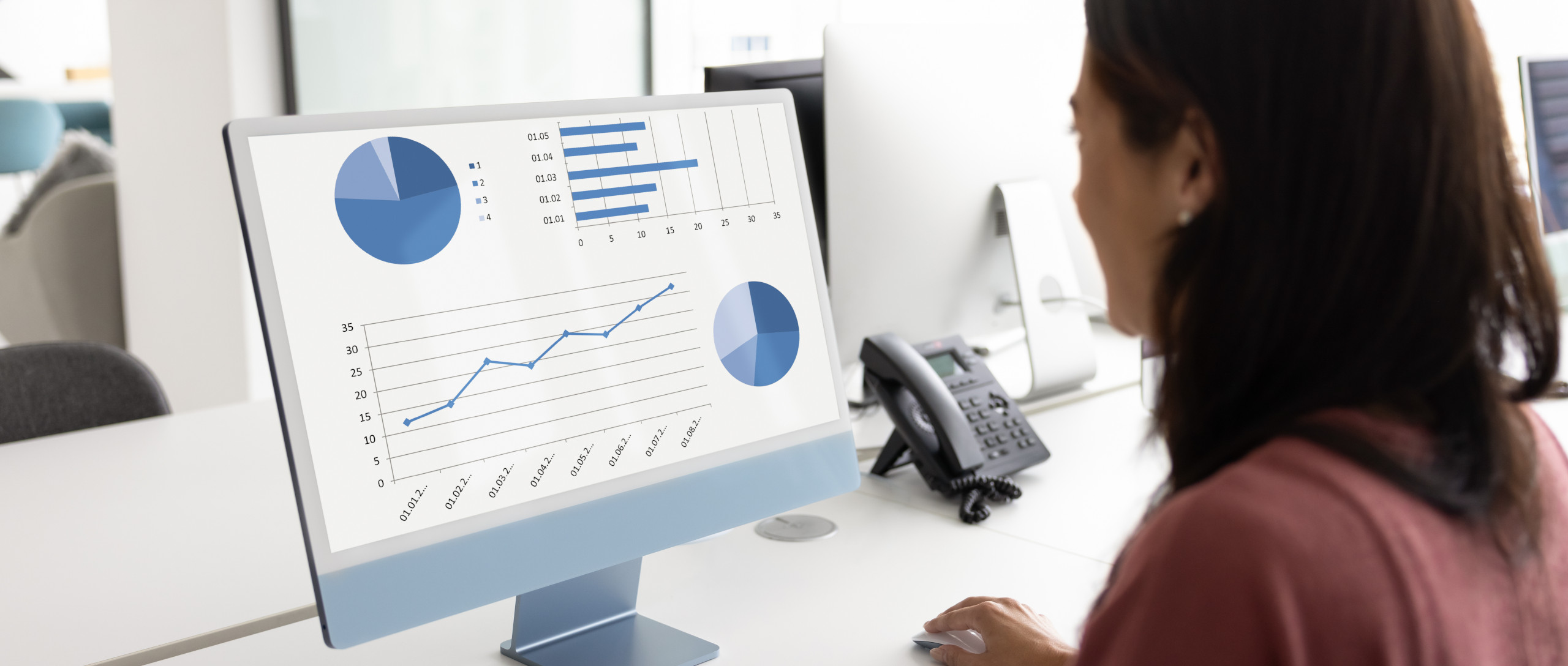 Business analytics dashboard with charts on a desktop monitor, illustrating import-export trade data and reporting