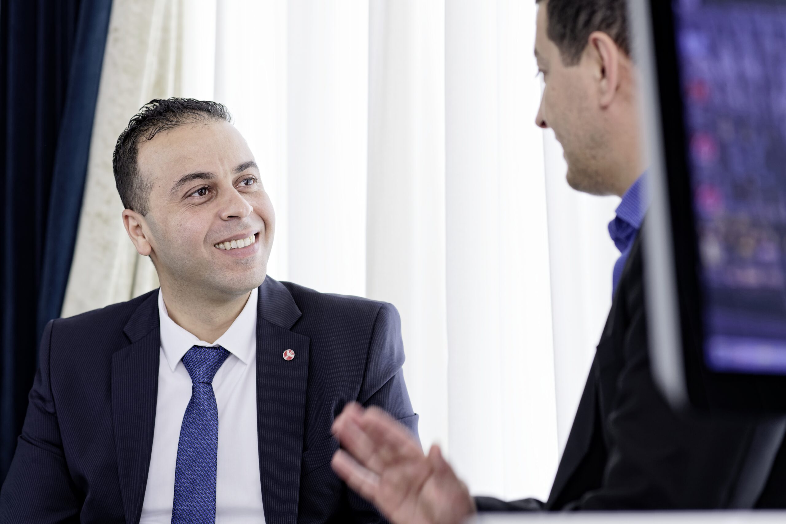 Two business professionals in discussion, illustrating market entry strategy planning for foreign investors setting up a factory in Vietnam