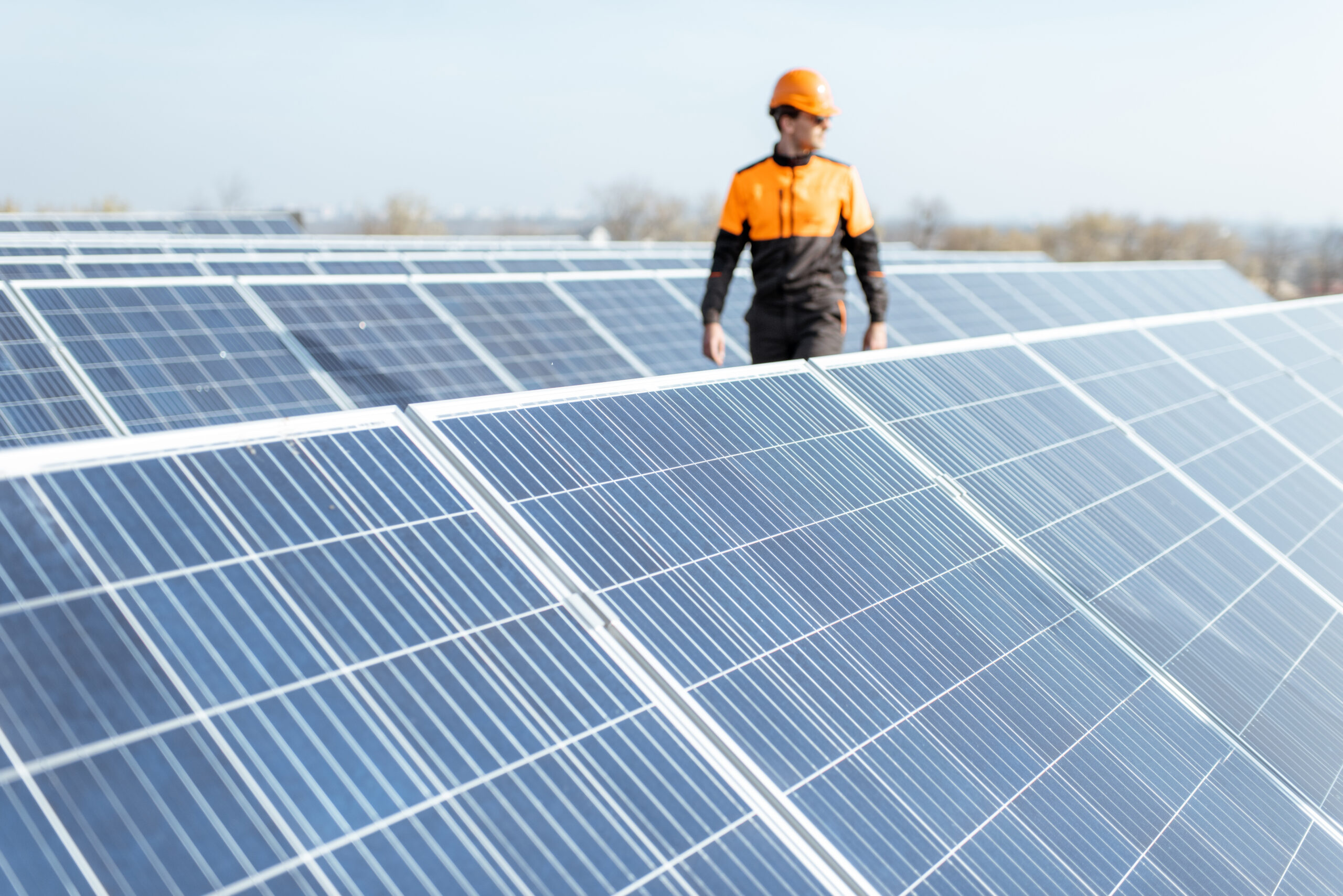 Engineer inspecting solar panels at an industrial power plant, illustrating FDI petrochemical and manufacturing legal services in Thanh Hoa Province